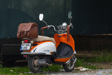 Side, Turkey â February 23 2022: A orange motorcycle stands in a parking against the backdrop of street, side viewのeditorial素材