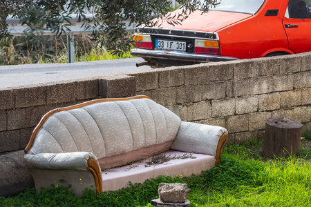 Side, Turkey â February 20 2022: close-up of an old dirty sofa stands on the street next to the roadのeditorial素材