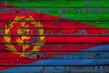 The national flag of Eritrea is painted on uneven boards. country symbol.