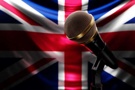 Microphone on the background of the National Flag of United Kingdom, realistic 3d illustration. music award, karaoke, radio and recording studio sound equipmentの写真素材