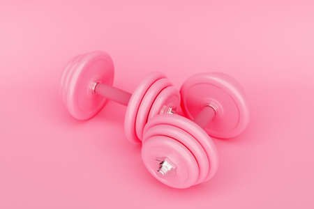 Shiny pink iron dumbbells on pink isolated background. 3D renderingの写真素材