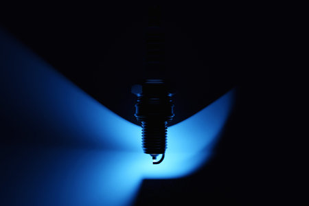 Close up of the spark plugs under blue lights on black background. 3d illustration. Car Repair Parts