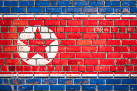 National flag of the North Korea on a grunge brick background.