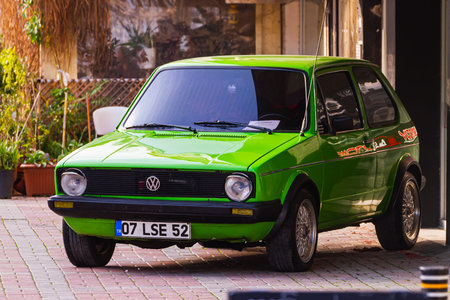 Side, Turkey -January 21, 2023: green Volkswagen Golf , front view, is parked on the street on a...