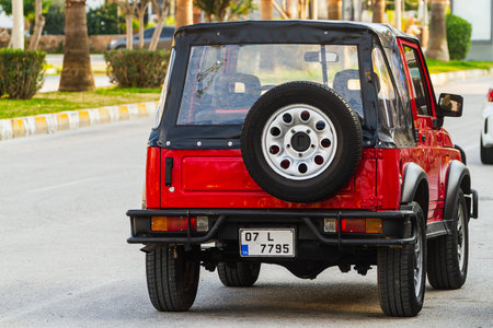 Side, Turkey -January 21, 2023: white Suzuki Jimmy Safari is parked on the street on a warm day...