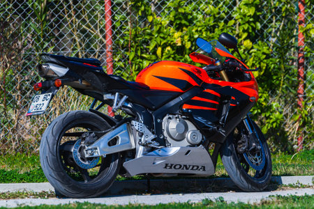 Side, Turkey -January 23, 2023: A black motorcycle stands in a parking against the backdrop of streetのeditorial素材