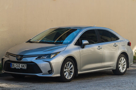 side; Turkey â January 23 2023: silver Toyota Corolla is parked on the street on a warm day against the backdrop of a beige wallのeditorial素材