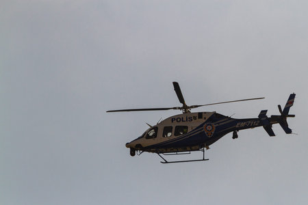 Side, Turkey -January 22, 2023: police helicopter in flight speeding against the blue skyのeditorial素材