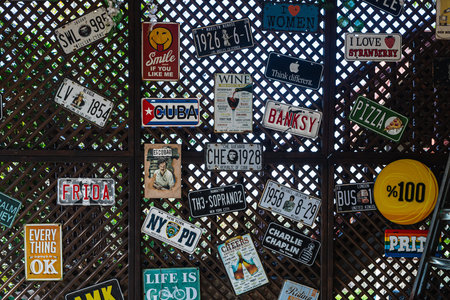 Side , Turkey - January 27, 2023: close-up of various car plate numbers posted on the wall of the cafe. Unusual decorのeditorial素材