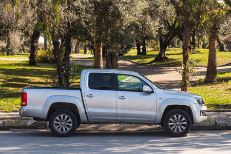 Antalya, Turkey â March 04 2022: silver Volkswagen Amarok is parked on the street on a warm day against the backdrop of a fence, parkのeditorial素材