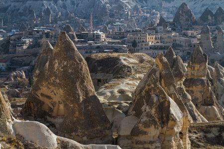 Goreme town on sunset in Cappadocia, Central Anatolia,Turkey. Morning view of the village of Goreme in Cappadocia on the background of the natural terrainのeditorial素材