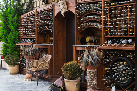 Side, Turkey -January 27, 2023: Atmospheric street wine cafe with many bottles of wine of different...