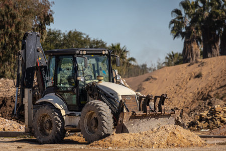 Side, Turkey â€“ February 09 2023: tractor-excavator for the demolition of an old building....