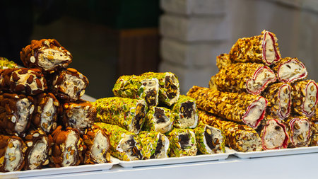 Eastern sweets. Traditional Turkish baklava with hazelnuts Arabian dessert, baklava, halva, Turkish delight in briquettes on a shop windowの写真素材
