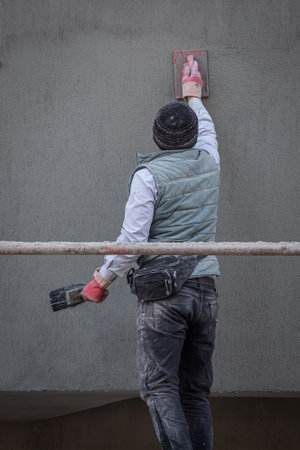Male professional bricklayer laying out the wall with new stone using a spatulaの写真素材