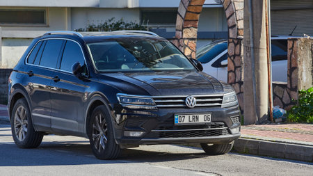 Side, Turkey - February 11, 2023: black Volkswagen Tiguan is parked on the street on a warm dayのeditorial素材