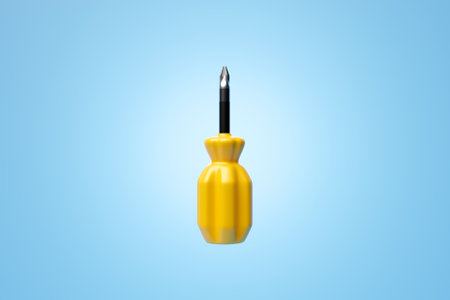 3D illustration of a yellow crosshead screwdriver hand tool isolated on a monocrome background. 3D render and illustration of repair and installation toolの写真素材