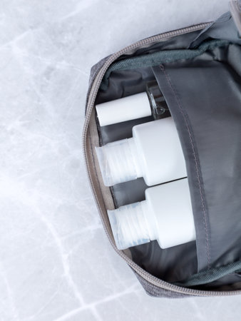Set of travel bottles and towels in cosmetic bagの写真素材