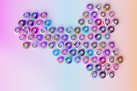 Multi-colored beads are scattered on a blue background. Close-up, macro, finishing of fashionable...
