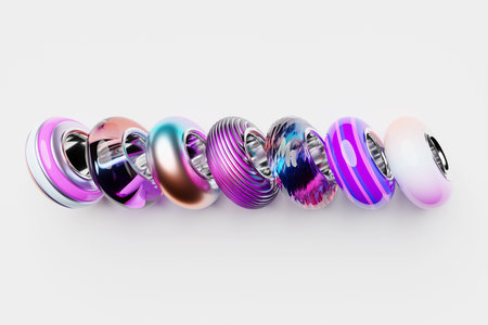 Multi-colored beads are scattered on a white background. Close-up, macro, finishing of fashionable...
