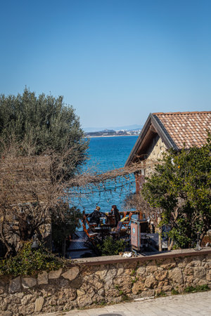 Side, Turkey - February 09, 2023: Restaurant , cafe with wooden furniture, lanterns, palm trees and vegetation on the seasideのeditorial素材