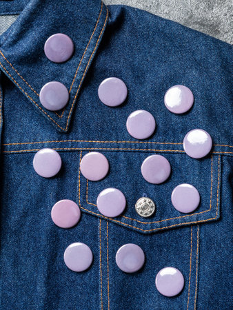 gray round badge button on denim jacket. Badge on a jacket close-up view. texture backgroundの写真素材