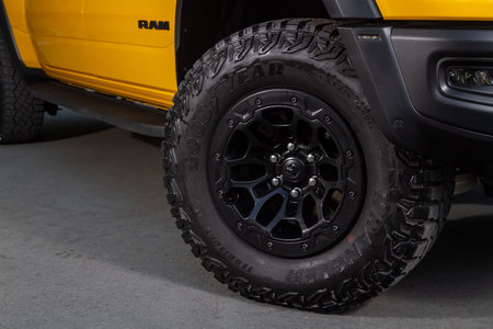 Novosibirsk, Russia - June 01, 2023: yellow Dodge Ram Trx Havok Edition, close-up car wheel with...
