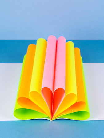 Colorful paper sheet background isolated on blue, close upの写真素材