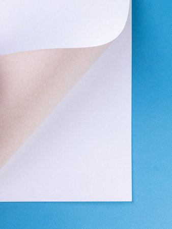White cardboard, paper sheet background isolated on blue, close up
