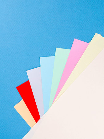 Colorful paper sheet background isolated on blue, close up