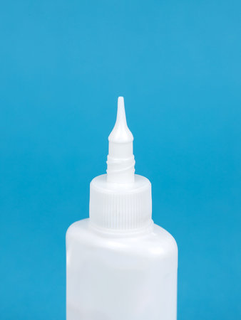 Glue bottle isolated on blue background, Close upの写真素材