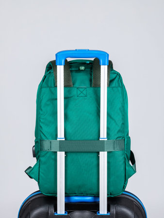 Close-up of a green men's backpack to put on the handle of a suitcase for easy travel