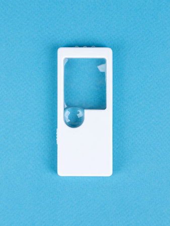 Magnifying Glass Isolated on bue Background, close upの写真素材
