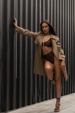 Fashion portrait of a young fashionable woman, dressed in skirt and top, posing on the street, enjoys rest in a city, summer street fashion. portrait of a joyful womanの写真素材