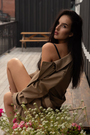 Portrait of a beautiful young model in black underwear enjoy day, on background modern city. The concept of the unity of women, peaceful moodの写真素材