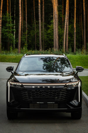 Novosibirsk, Russia - August 29 , 2023: black EXEED RX, front view against the background of modern architectureのeditorial素材