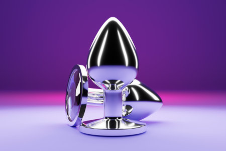 Silver butt anal plugs sex toys on purple isolated background. 3D illustration. Empty space for your textの写真素材