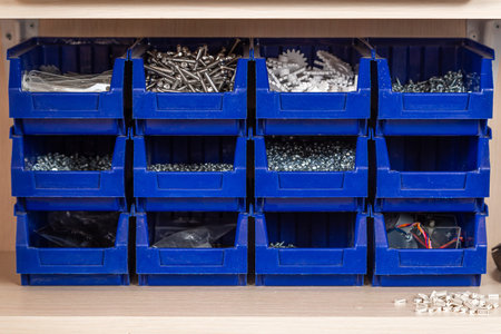 Blue box with small construction objects. Many storage compartments are filled with construction...