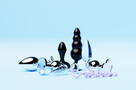 Colorful butt anal plugs sex toys on blue isolated background. 3D illustration. Empty space for your textの写真素材