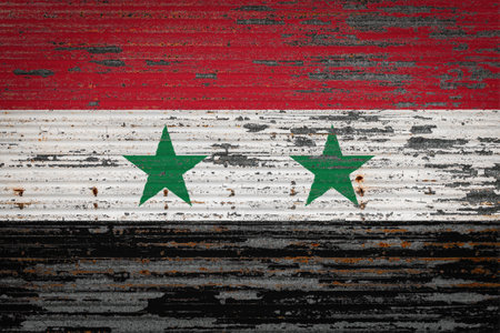 Close-up of old metal wall with national flag of Syria. Concept of Syria export-import, storage of goods and national delivery of goods. Flag in grunge styleの写真素材