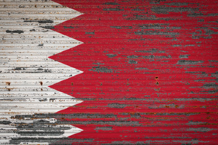 Close-up of old metal wall with national flag of Bahrain. Concept of Bahrain export-import, storage of goods and national delivery of goods. Flag in grunge styleの写真素材