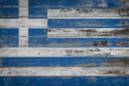 The national flag of Greece is painted on uneven wooden boards. Country symbol.の写真素材