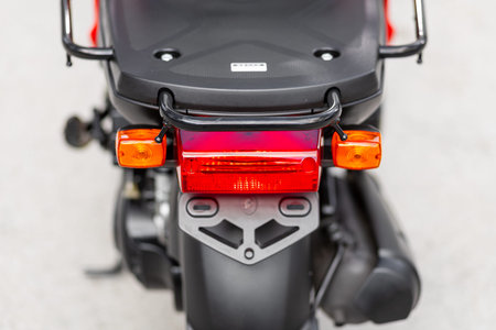 Novosibirsk, Russia - May 01, 2024: red moped Yamaha Gear, Close up detail on one of the LED red...