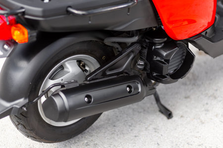 Novosibirsk, Russia - May 01, 2024: red moped Yamaha Gear, Motorcycle items close-up: wheel, wing.