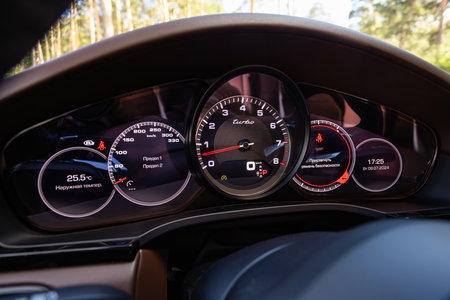 Novosibirsk, Russia - July 10, 2024: Porsche Cayenne, dashboard of the car is illuminated by bright illumination. Speedometer, circle tachometer, oil and fuel levelのeditorial素材