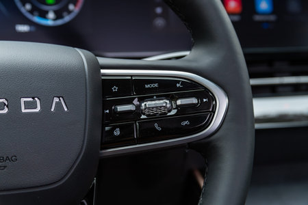 Novosibirsk, Russia - July 10, 2024: OMODA C5, Close up of car steering wheel with function buttons