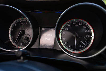 Novosibirsk, Russia - July 10, 2024: Suzuki Swift , Car dashboard with white backlight: Odometer,...