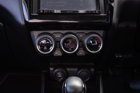 Novosibirsk, Russia - July 10, 2024: Suzuki Swift, black car interior: climate control view with air...