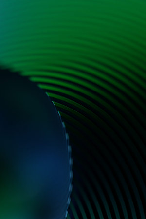Close-up of an abstract green geometric shape against a monochrome background, emphasizing sharp...