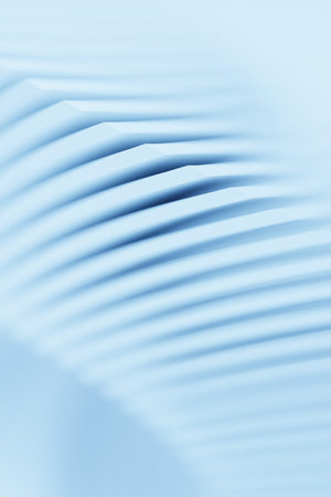 Close-up of an abstract blue geometric shape against a monochrome background, emphasizing sharp...
